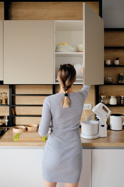 Woman home taking something from a kitchen store