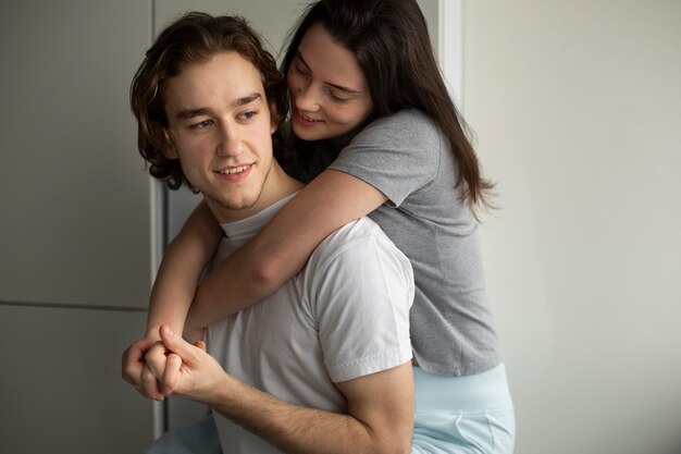 Woman hugging boyfriend while smiling