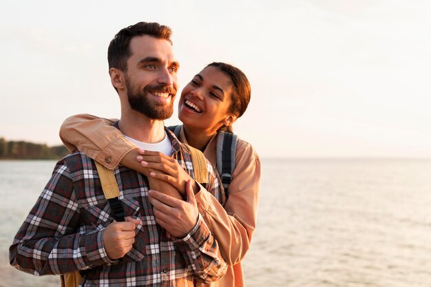 Woman hugging her boyfriend from behind with copy space