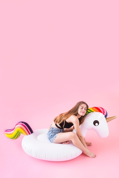 Woman on inflatable unicorn