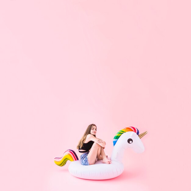 Woman on inflatable unicorn