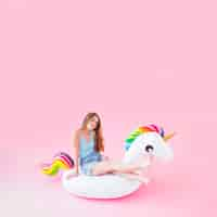 Free photo woman on inflatable unicorn