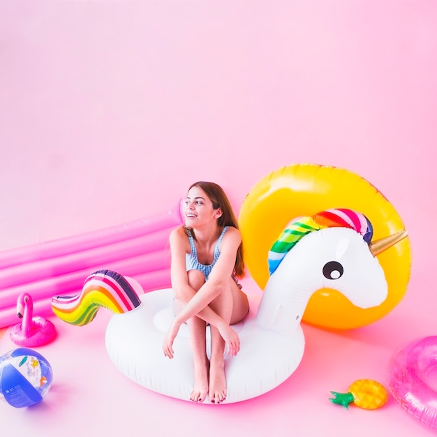 Woman on inflatable unicorn