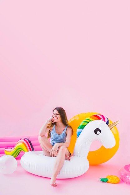 Woman on inflatable unicorn