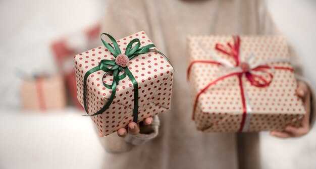 A woman is holding a beautiful Christmas gifts.