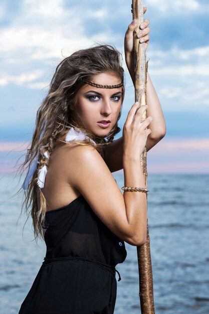 Woman is posing with a stick