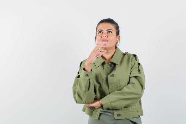 woman in jacket, t-shirt looking up and looking dreamy