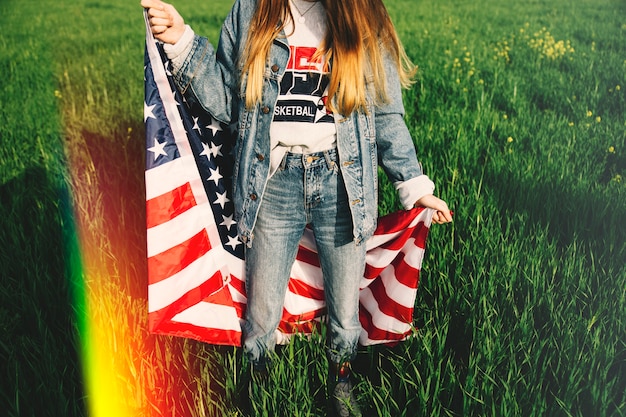 Woman in jeans staying in field