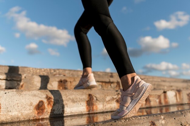 Woman jogging on stairs close-up