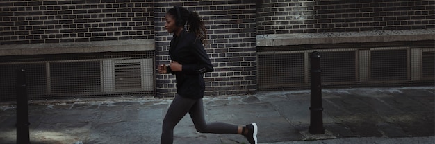 Free photo woman jogging through the city