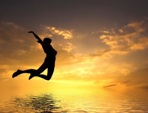 Woman jumping in the beach