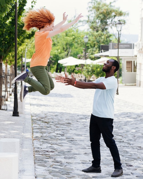 Free photo woman jumping in her lover's arms