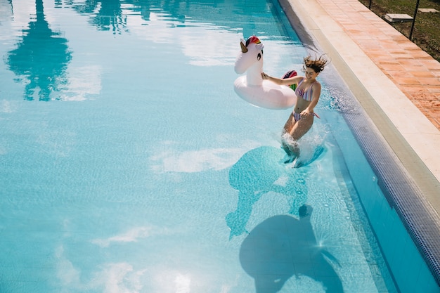 Woman jumping into pool