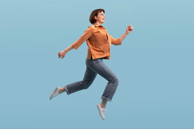 woman jumping isolated on blue