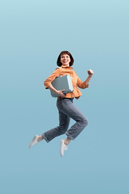 Woman jumping isolated on blue