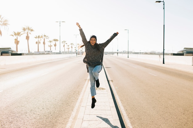 Woman jumping on street
