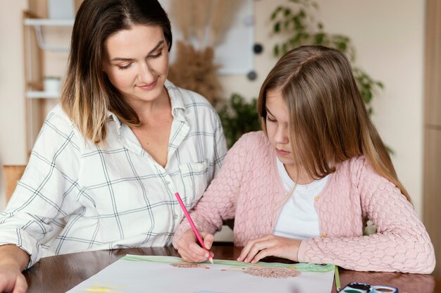 Woman and kid drawing together