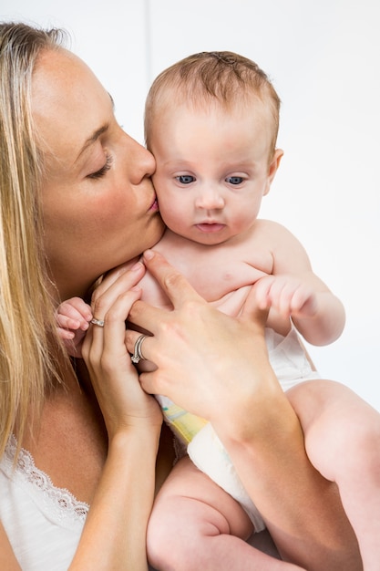 Woman kissing a baby