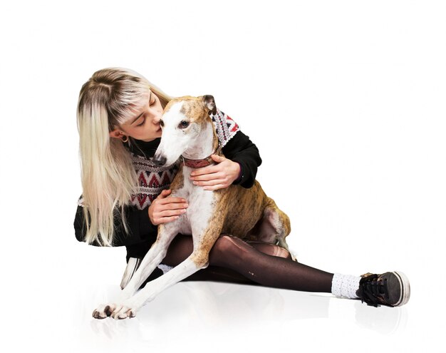 Woman kissing a dog on the head