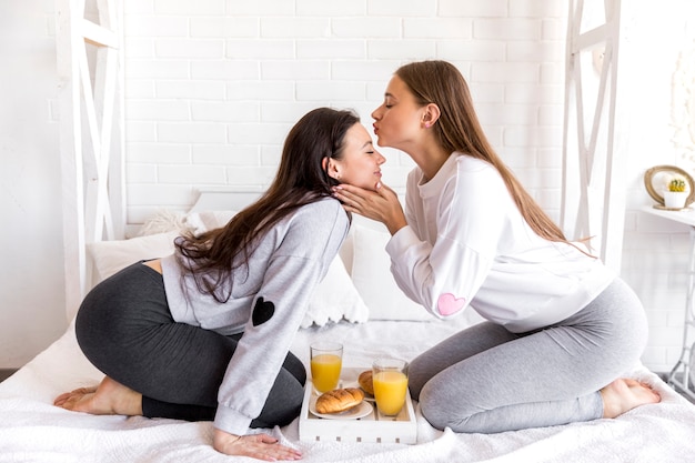 Женщина целует подругу в лоб