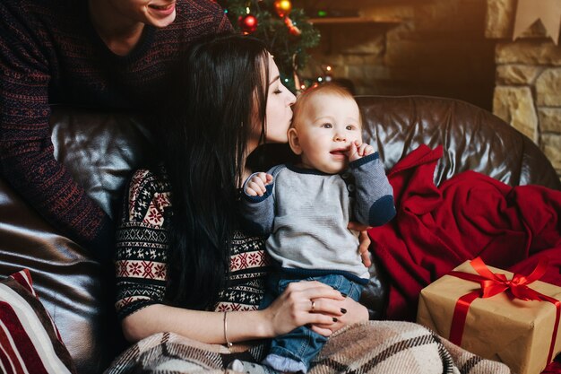 Woman kissing her baby on the head