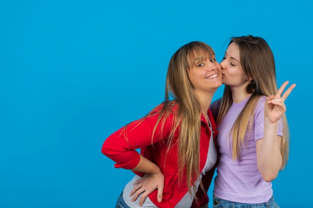 Woman kissing her childhood girlfriend