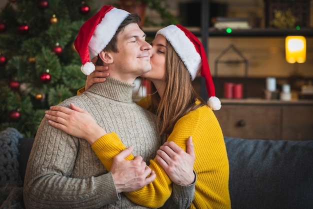 Free photo woman kissing man on cheek