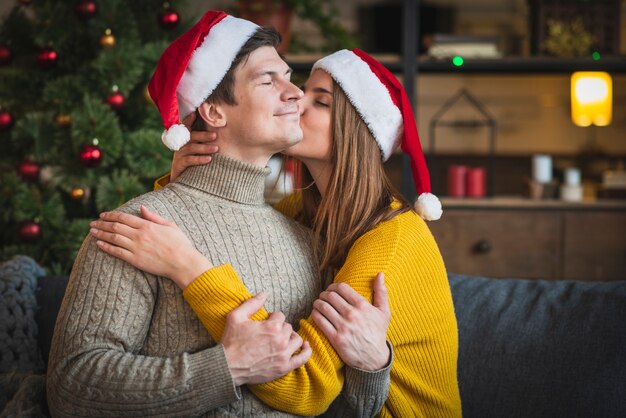 Woman kissing man on cheek