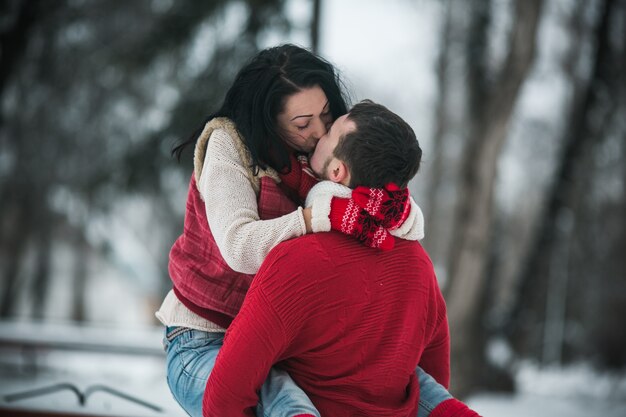 "Woman kissing man on his hands"