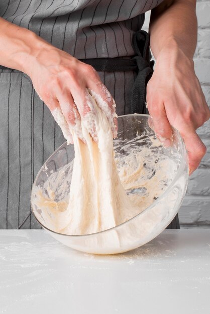 Woman kneading dough in bowl