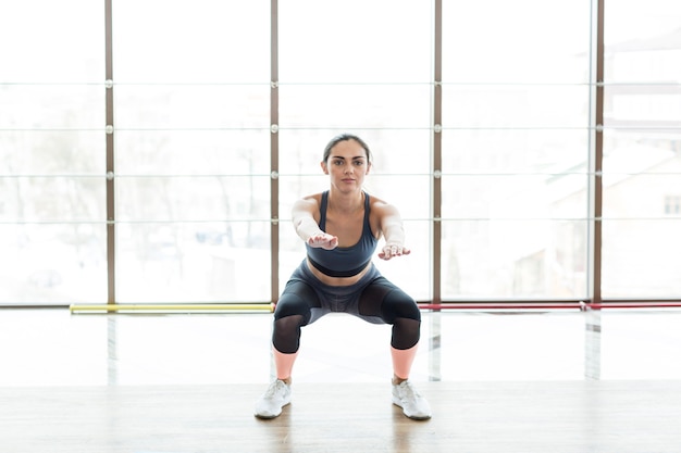 Free photo woman knee bending at window