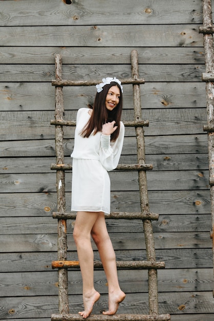 Woman on a ladder smiling