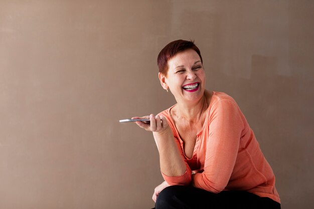 Woman laughing and holding phone