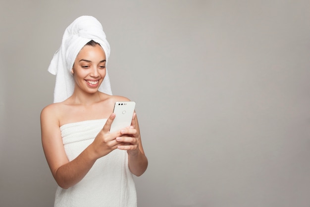 Woman laughing and texting after bath