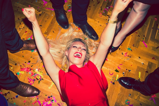 Woman laying on the floor of the disco and laughing