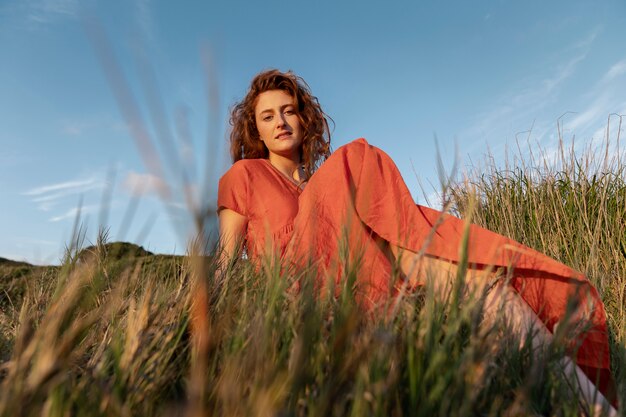 Woman laying on grass low angle