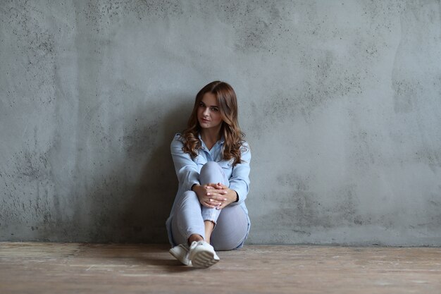 Woman leaning against wall