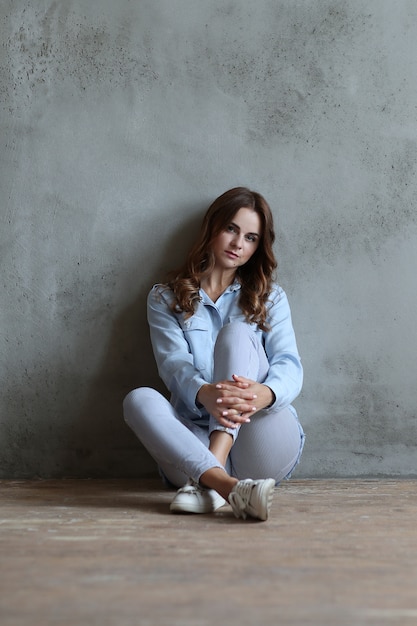 Woman leaning against wall