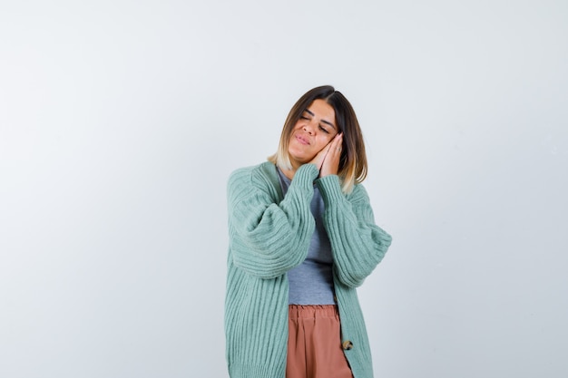 Woman leaning on palms as pillow in casual clothes and looking peaceful. front view.