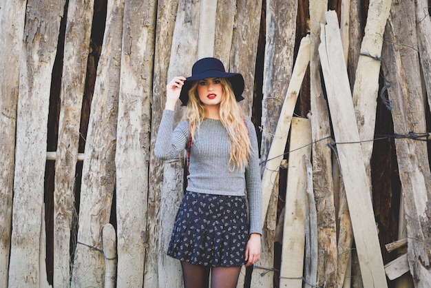 Free photo woman leaning on a wooden boards