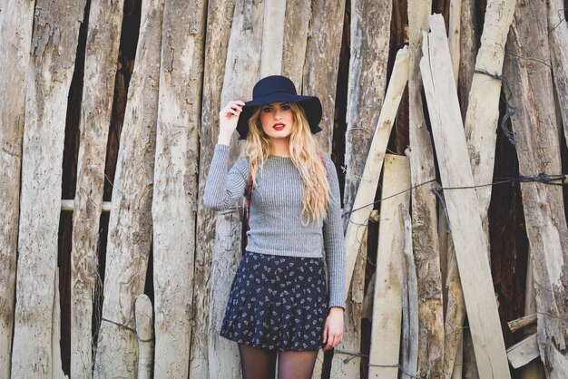 Woman leaning on a wooden boards