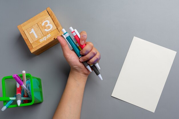 A woman left-hand with a pen.Left hander day concept.