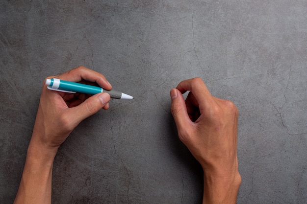 Free photo a woman left-hand with a pen.left hander day concept.