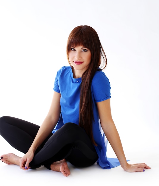 Woman in leggings sitting on the floor