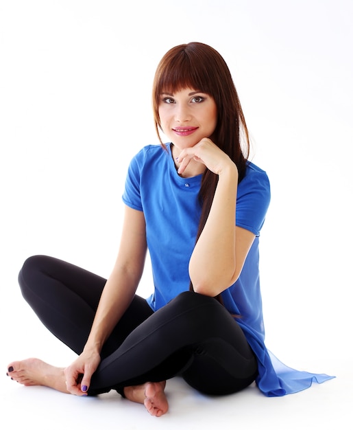 Woman in leggings sitting on the floor