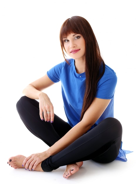 Woman in leggings sitting on the floor