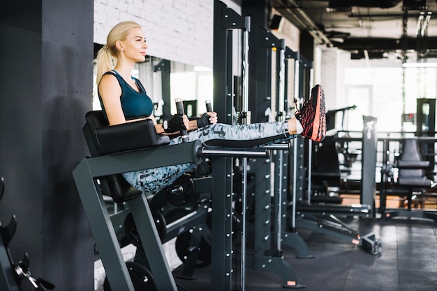 Woman lifting legs on exercise machine