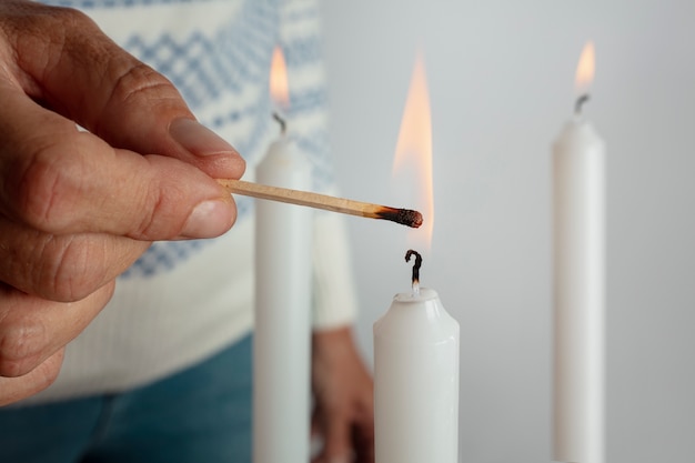 Woman lighting wreath candle on fire