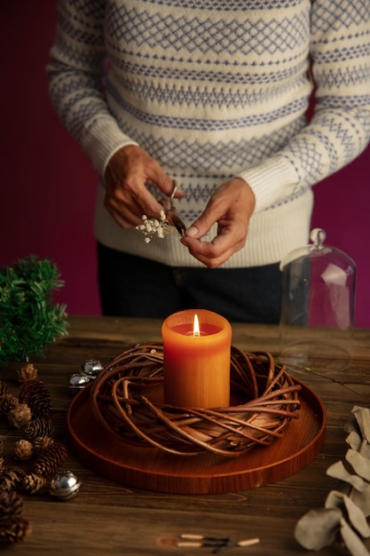 Woman lighting wreath candle on fire