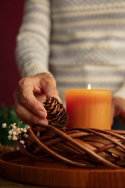 Woman lighting wreath candle on fire